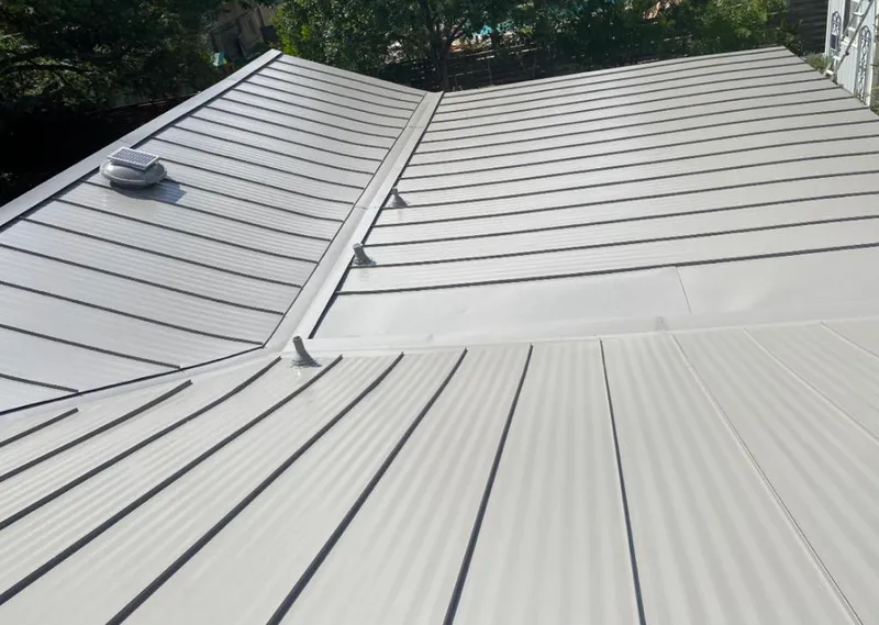 Solar attic fan installed on a metal roof for Roof Ventilation in Tea